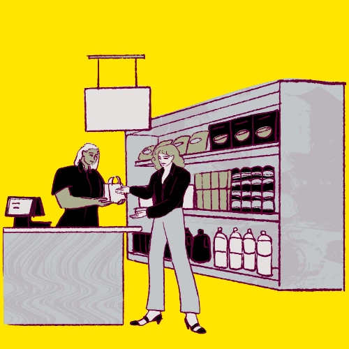 A person receives a bag from a cashier at a store